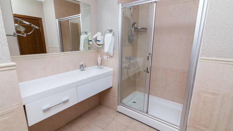 Cam duşakabinli, sade bir banyo