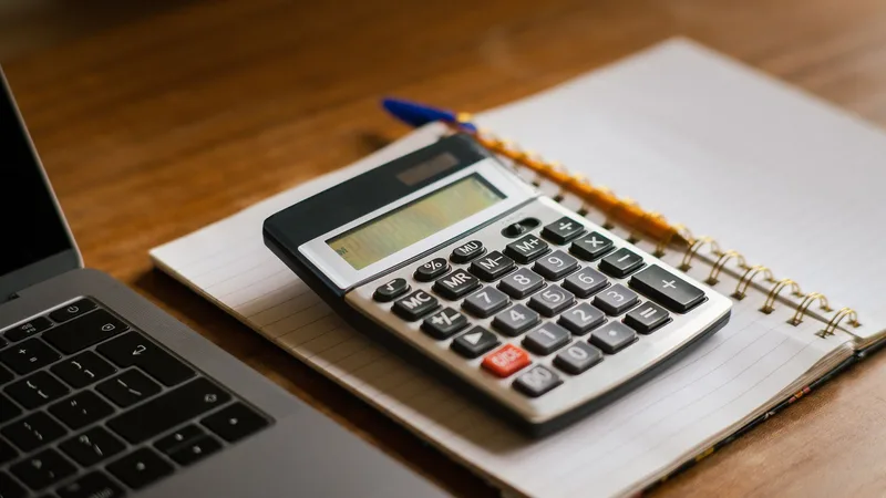 Hesap makinesi, defter ve dizüstü bilgisayarla bütçe planlama